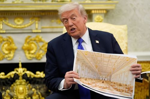 President Donald Trump holds an artist rendering of the interior of the new White House ballroom.