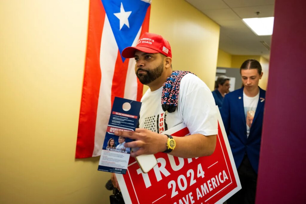 FILE - Juan Ojeda, 33, who is Puerto Rican, attends a grand opening event at the