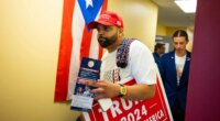 FILE - Juan Ojeda, 33, who is Puerto Rican, attends a grand opening event at the