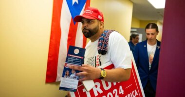 FILE - Juan Ojeda, 33, who is Puerto Rican, attends a grand opening event at the