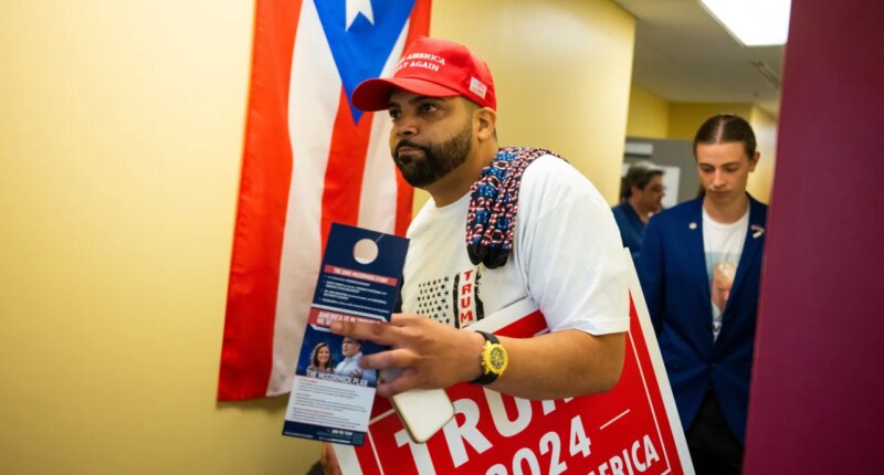 FILE - Juan Ojeda, 33, who is Puerto Rican, attends a grand opening event at the