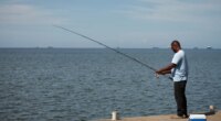 A man fishes in Cocorite, Trinidad and Tobago, Friday, Oct. 3, 2025. (AP Photo/Anselm Gibbs)