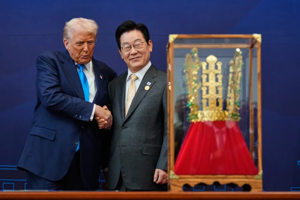 President Donald Trump shakes hands with South Korean President Lee Jae Myung as he receives a gift of a gold crown and an award of the Grand Order of Mugunghwa, not seen, during a high honor ceremony at the Gyeongju National Museum in Gyeongju, South Korea, Wednesday, Oct. 29, 2025. (AP Photo/Mark Schiefelbein)