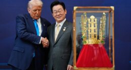 President Donald Trump shakes hands with South Korean President Lee Jae Myung as he receives a gift of a gold crown and an award of the Grand Order of Mugunghwa, not seen, during a high honor ceremony at the Gyeongju National Museum in Gyeongju, South Korea, Wednesday, Oct. 29, 2025. (AP Photo/Mark Schiefelbein)