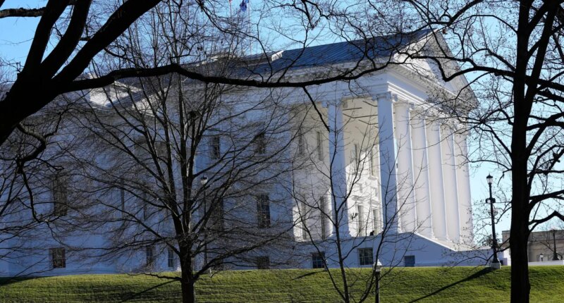 FILE - The state and U.S. flags fly over the Virginia State Capitol as the 2024 session of the Virginia General Assembly gets underway, Jan. 10, 2024, in Richmond, Va. (AP Photo/Steve Helber, File)