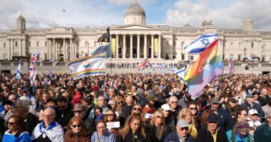 Britain is 'obviously not a safe country': Thousands of Jewish people come together to mourn two men killed in terror attack