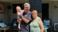 Howard and Shirley Hill with their great-granddaughter outside their beloved Dicky Beach Holiday Park home.