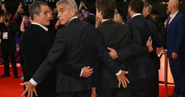 George Clooney puts on cheeky display with pals at Jay Kelly premiere