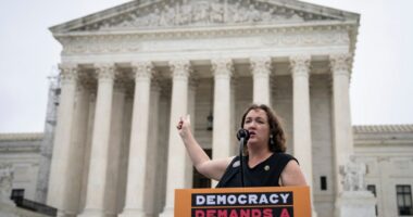 Rep. Katie Porter speaks during a small rally in front of the Supreme Court building