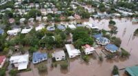 An aerial drone view of houses surrounded by floodwater on March 31, 2022 in Lismore, Australia. Evacuation orders have been issued for towns across the NSW Northern Rivers region, with flash flooding expected as heavy rainfall continues. It is the second major flood event for the region this month. (Photo by Dan Peled/Getty Images)