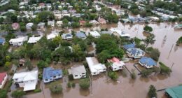An aerial drone view of houses surrounded by floodwater on March 31, 2022 in Lismore, Australia. Evacuation orders have been issued for towns across the NSW Northern Rivers region, with flash flooding expected as heavy rainfall continues. It is the second major flood event for the region this month. (Photo by Dan Peled/Getty Images)
