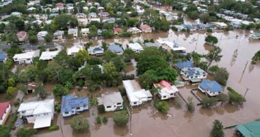 An aerial drone view of houses surrounded by floodwater on March 31, 2022 in Lismore, Australia. Evacuation orders have been issued for towns across the NSW Northern Rivers region, with flash flooding expected as heavy rainfall continues. It is the second major flood event for the region this month. (Photo by Dan Peled/Getty Images)