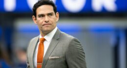 Mark Sanchez walks on the field before an NFL football game