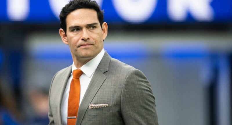 Mark Sanchez walks on the field before an NFL football game