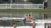 Several people canoe in flooded Utah streets