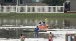 Several people canoe in flooded Utah streets