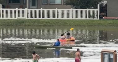 Several people canoe in flooded Utah streets