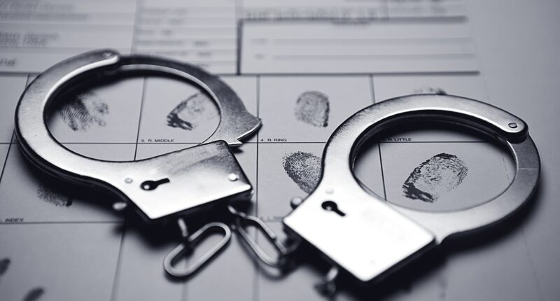 Photo of Handcuffs and fingerprints