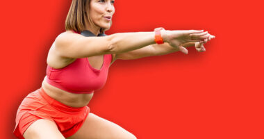 An attractive woman between 30 and 40 years old is doing sports outdoors.The woman is doing a squat to work her legs.Concept of adult women doing sports.