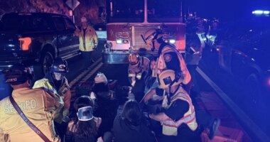This image provided by San Bernardino County Fire shows the scene on a highway near Running Springs, Calif., where a bus overturned on Sunday, Nov. 9, 2025. (San Bernadino County Fire via AP