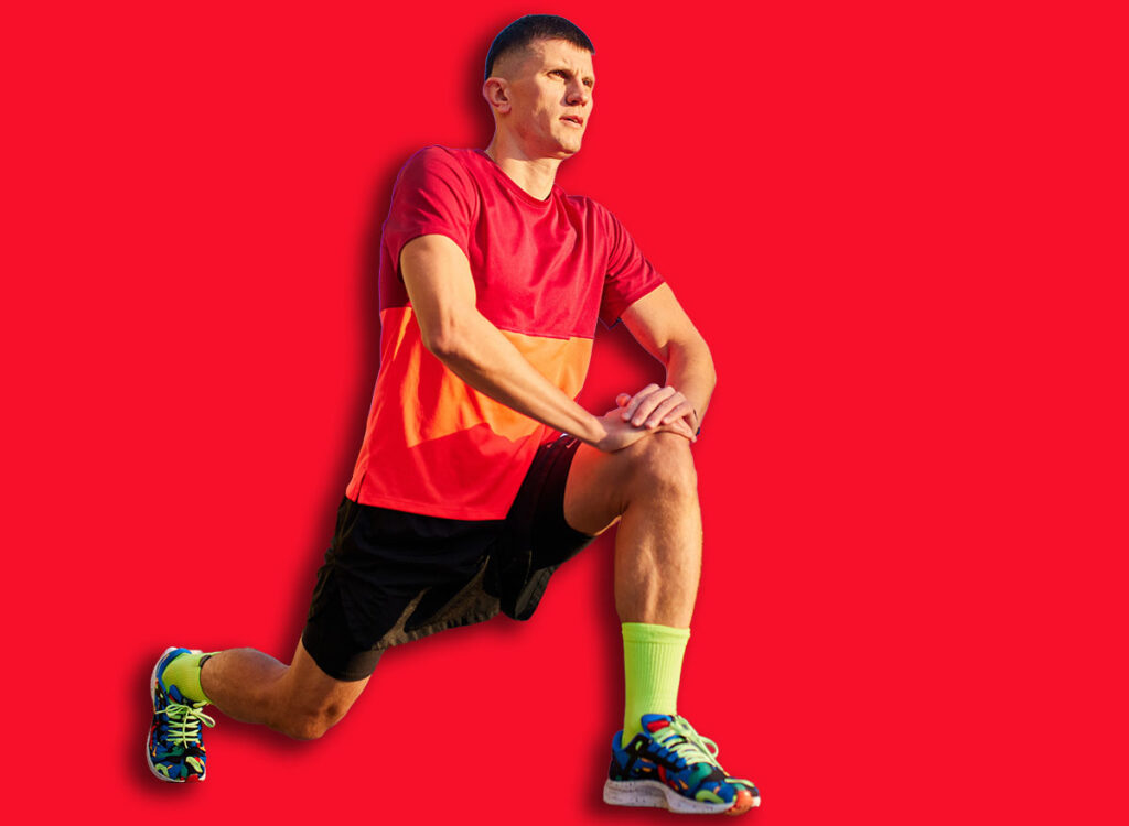 Warming-up muscles exercises before training. Man in sportswear, running athlete doing ATG split squat before training outdoors. Concept of sport, active and healthy lifestyle, competition, marathon