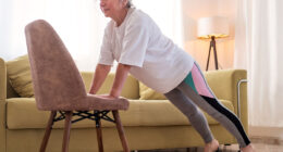 Senior caucasian woman doing yoga at home on chair