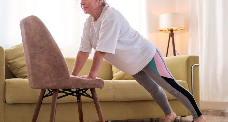 Senior caucasian woman doing yoga at home on chair