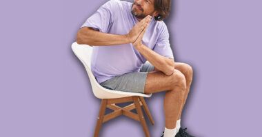 Middle age man smiling confident sitting on chair stretching at sport center