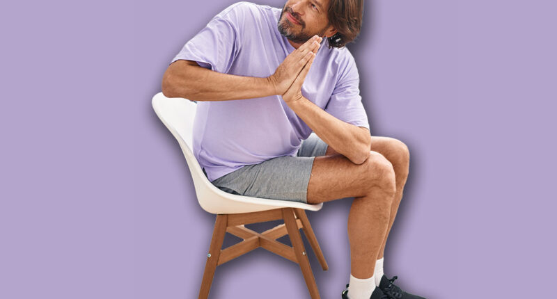 Middle age man smiling confident sitting on chair stretching at sport center