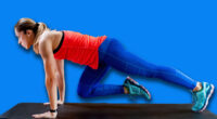 Woman doing mountain climbers on High-intensity interval training at home