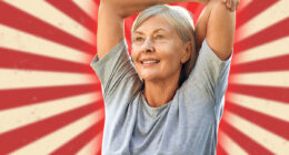 A joyful senior woman is gracefully stretching her arms outdoors in a lush, expansive green park, fully embracing a life of wellness, vitality, and the beauty of nature around her