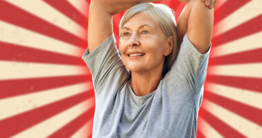 A joyful senior woman is gracefully stretching her arms outdoors in a lush, expansive green park, fully embracing a life of wellness, vitality, and the beauty of nature around her