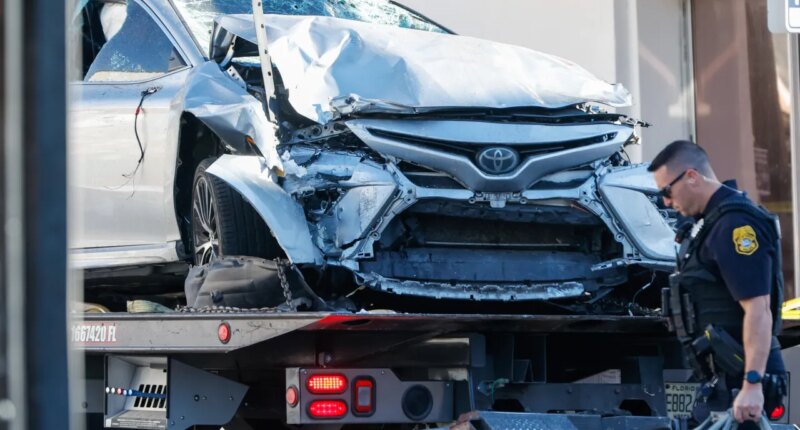 A vehicle that crashed into a local business is towed away, while law enforcement investigate the scene on Saturday, Nov. 8, 2025, in Tampa, Fla. (Jefferee Woo/Tampa Bay Times via AP)