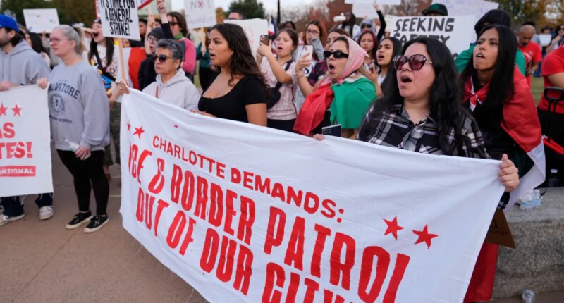 People protest against federal immigration enforcement Saturday, Nov. 15, 2025, in Charlotte, N.C. (AP Photo/Erik Verduzco)