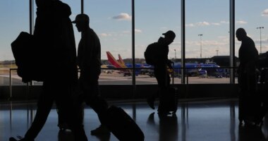 Southwest Airlines planes sit at gates as travelers walk through Baltimore/Washington International Thurgood Marshall Airport in Baltimore, Monday, Nov. 10, 2025. (AP Photo/Stephanie Scarbrough)