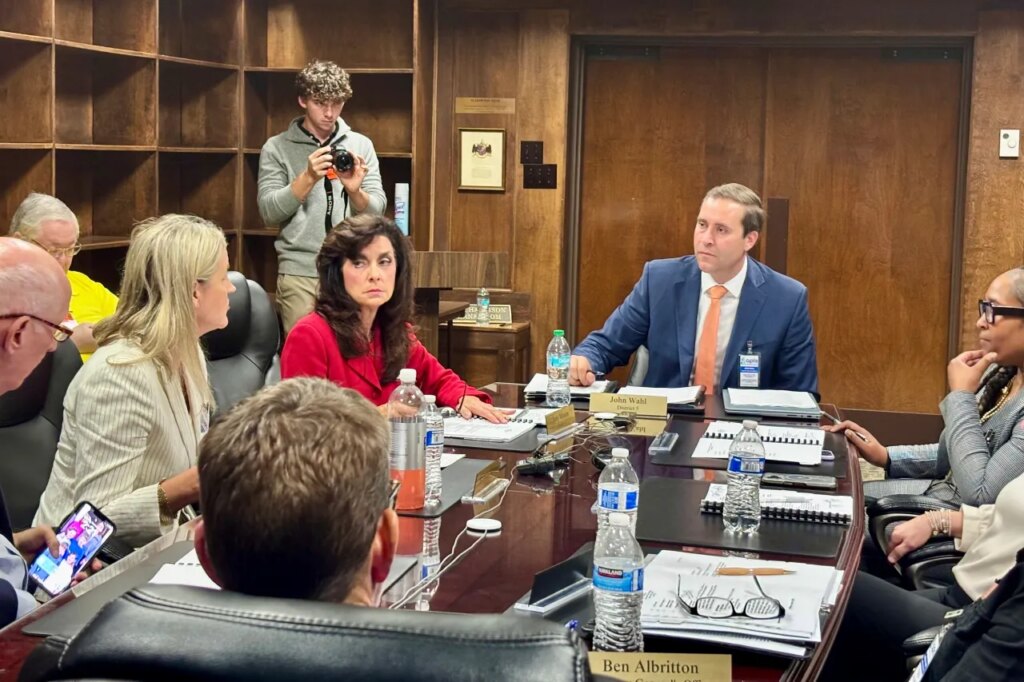 John Wahl, chairman of the Alabama Public Library Service Board of Directors, center right, listens during a meeting in Montgomery, Ala., Thursday, Nov. 20, 2025. (AP Photo/Kim Chandler)