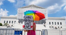 FILE - A protester stands outside of the Supreme Court, June 26, 2025, in Washington. (AP Photo/Mariam Zuhaib, File)