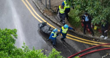 Workers remove a body from a fire which broke out Wednesday at Wang Fuk Court, a residential estate in the Tai Po district of Hong Kong