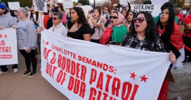 People protest against federal immigration enforcement Saturday, Nov. 15, 2025, in Charlotte, N.C. (AP Photo/Erik Verduzco)