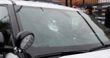 The wind shield of a Chicago police vehicle is smashed as people protesting the actions of federal immigration agents in Little Village clash with Chicago police officers Saturday, Nov. 8, 2025, in Chicago. (AP Photo/Erin Hooley)