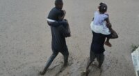 FILE - Residents wade through a flooded street in the aftermath of Hurricane Melissa in Petit-Goave, Haiti, Oct. 30, 2025. (AP Photo/Odelyn Joseph, File)