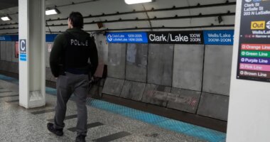 A Chicago police officer patrols the Clark Street and Lake Street Blue Line stop where a man doused a woman in liquid and set her on fire on the train Monday night, Tuesday, Nov. 18, 2025, in Chicago. (AP Photo/Erin Hooley)