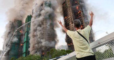 Fire tears through Hong Kong housing complex, killing at least 13 with others reported trapped