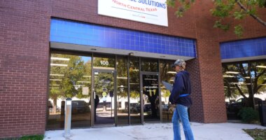 Cela Bratton Williams walks into the Workforce Solutions of North Central Texas office, Thursday, Oct. 30, 2025, in Plano, Texas. (AP Photo/Tony Gutierrez)