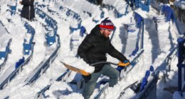 FILE - A stadium worker clears snow from seats before an NFL wild-card playoff football game between the Buffalo Bills and the Pittsburgh Steelers, Jan. 15, 2024, in Buffalo, N.Y. (AP Photo/Jeffrey T. Barnes, File)