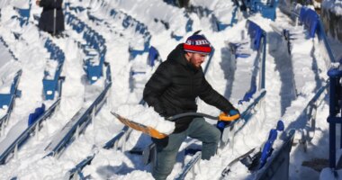 FILE - A stadium worker clears snow from seats before an NFL wild-card playoff football game between the Buffalo Bills and the Pittsburgh Steelers, Jan. 15, 2024, in Buffalo, N.Y. (AP Photo/Jeffrey T. Barnes, File)