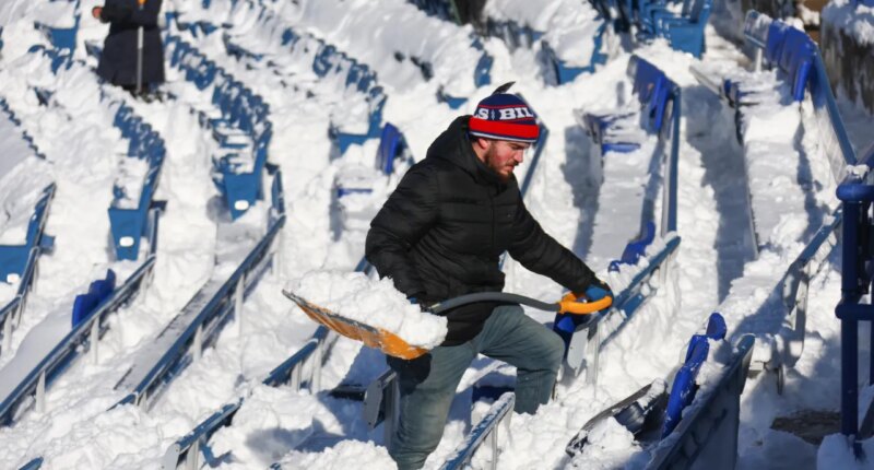 FILE - A stadium worker clears snow from seats before an NFL wild-card playoff football game between the Buffalo Bills and the Pittsburgh Steelers, Jan. 15, 2024, in Buffalo, N.Y. (AP Photo/Jeffrey T. Barnes, File)