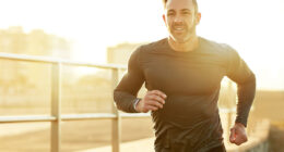 Man, running and sunset on beach, sports workout and promenade activity for health. Mature male person, physical challenge and training for marathon, outdoor fitness and cardiovascular exercise