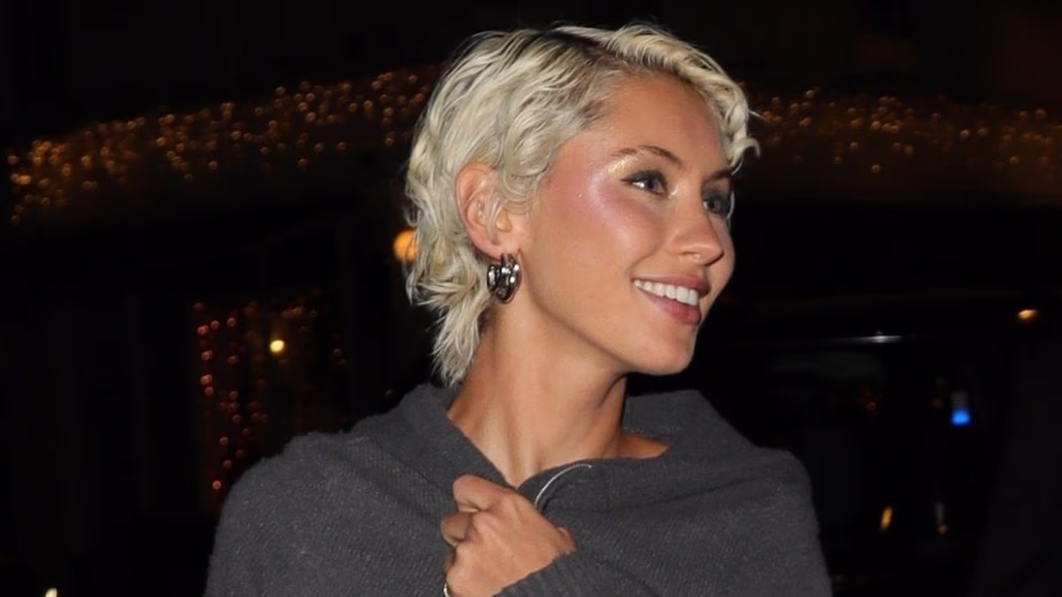 Iris Law puts on a leggy display in a slinky green minidress