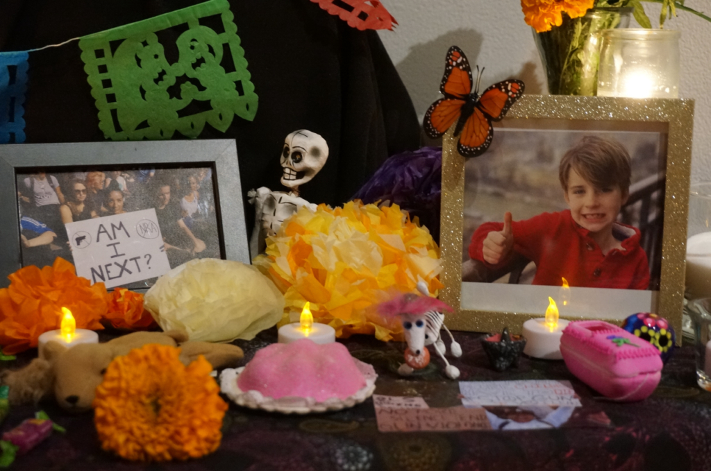 Photos commemorating the deadly shooting in August during Mass at Annunciation Catholic School in Minneapolis are part of an “ofrenda” marking Día de Muertos (Day of the Dead) at El Colegio High School in Minneapolis on Saturday, Nov. 1, 2025. (AP Photo/Giovanna Dell
